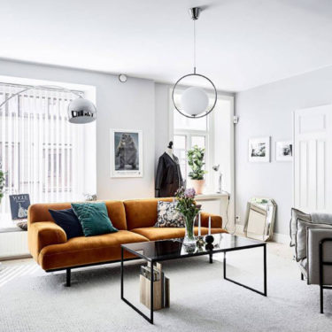 A house with a mustard yellow sofa